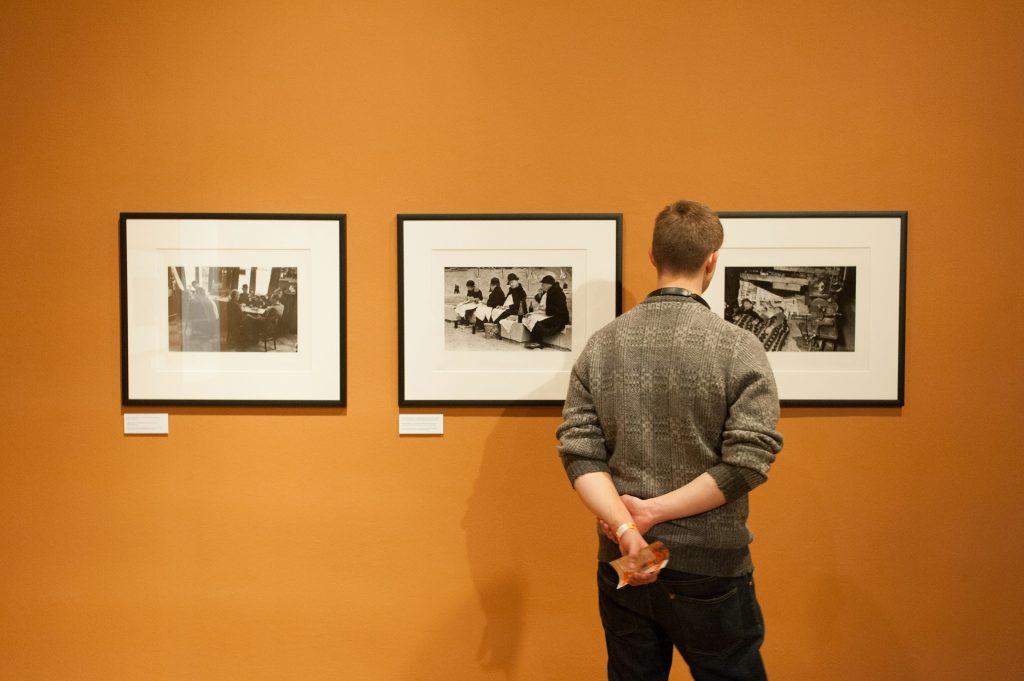 Image of a man looking at art pieces