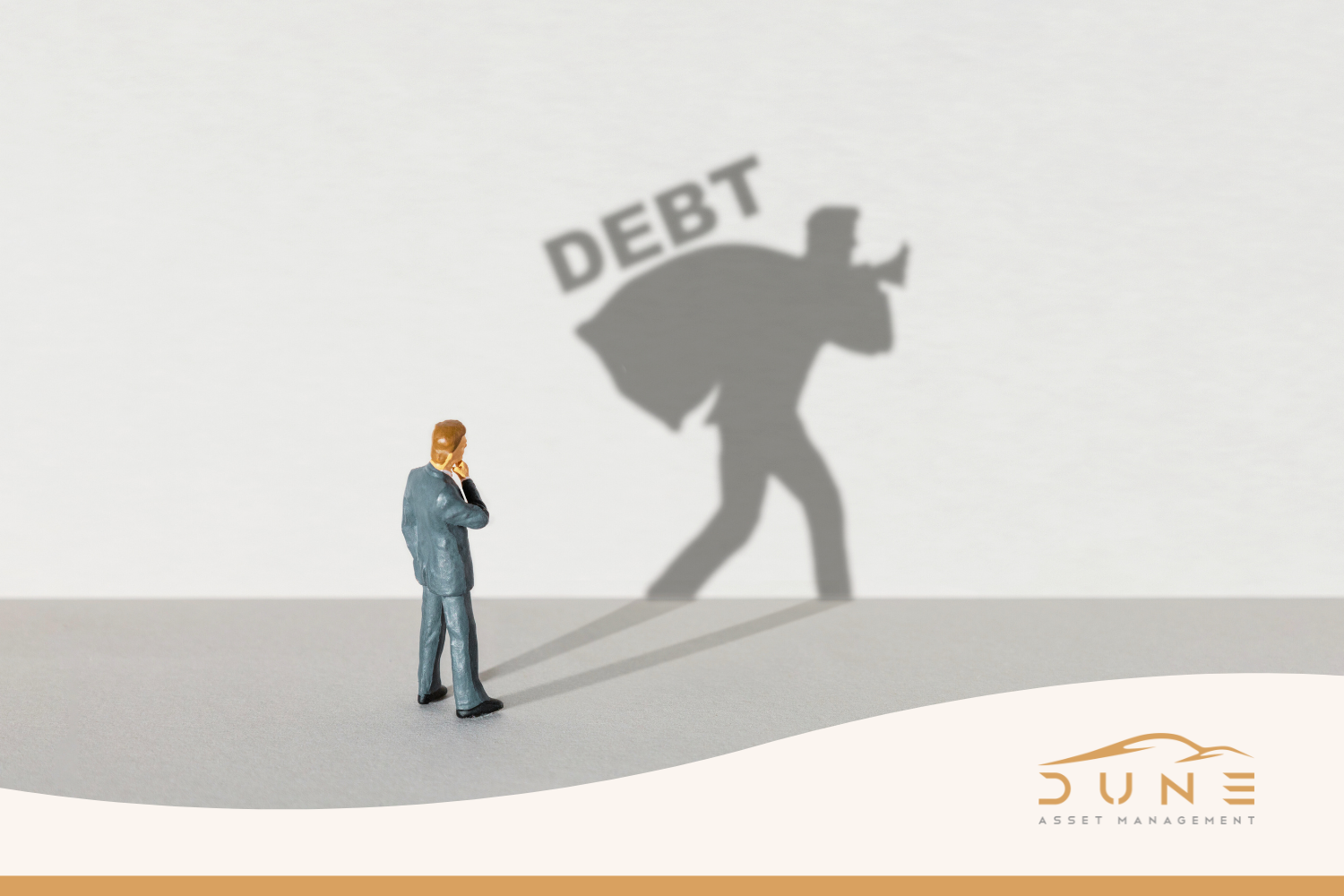 Cover image of a man holding standing with his shadow depicting a man carrying a heavy sack signalling debt